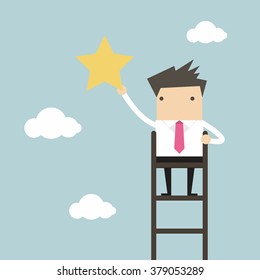 Businessman on a ladder grab star in the sky