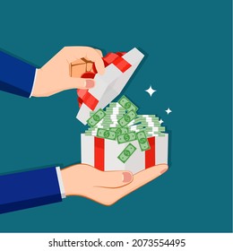  A businessman opens a gift box with a pile of banknotes. financial concept