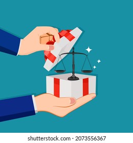 A businessman opens a gift box with a scale. concept of justice