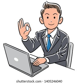 A businessman operating a computer gives an OK sign