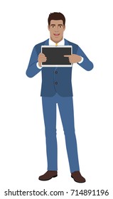 Businessman pointing at blank digital tablet PC. Full length portrait of Black Business Man in a flat style. Vector illustration.