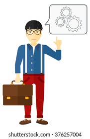 Businessman pointing at cogwheels.