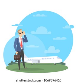 Businessman with private jet standing near the plane with briefcase.