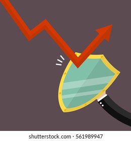 Businessman is protected by a shield from graph down