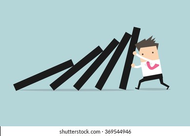 Businessman pushing hard against falling deck of domino tiles. 