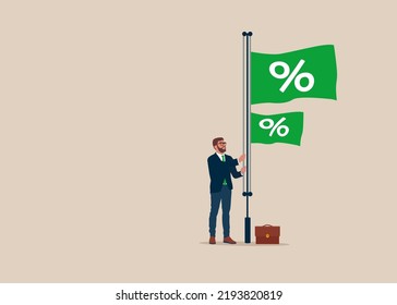 Businessman Raises A Flag With A Percentage Symbol To The Top Of A Pole. Interest Rate Hikes Due To Rising Inflation. US Fed Raises Interest Rates.