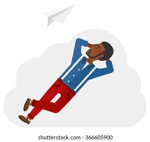 Businessman relaxing on cloud.