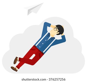 Businessman relaxing on cloud.