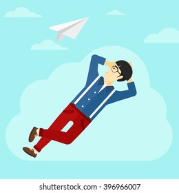 Businessman relaxing on cloud.