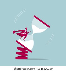 Businessman rides on the hourglass. Isolated on blue background.