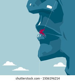 Businessman rock climbing on a huge face. The background is blue.