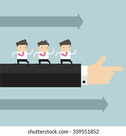 Businessman running in the same direction with big businessman's hand pointing