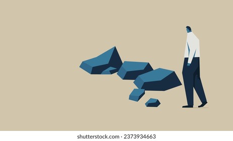 A businessman runs into an obstacle. There are several rocks in front of him.
