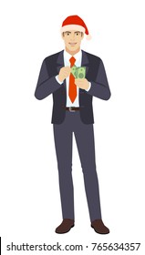 Businessman in Santa hat with money. Full length portrait of businessman in a flat style. Vector illustration.