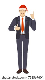 Businessman in Santa hat pointing up and showing thumb up.  Full length portrait of businessman in a flat style. Vector illustration.