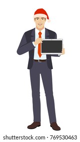 Businessman in Santa hat showing blank digital tablet PC. Full length portrait of businessman in a flat style. Vector illustration.