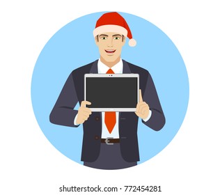 Businessman in Santa hat showing blank digital tablet PC. Portrait of businessman character in a flat style. Vector illustration.