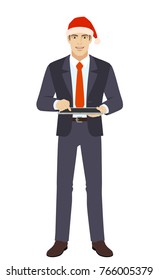 Businessman in Santa hat using digital tablet PC. Full length portrait of businessman in a flat style. Vector illustration.