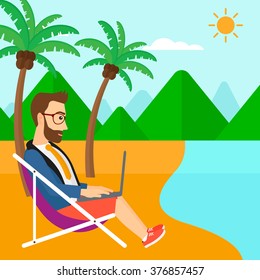 Businessman sitting in chaise lounge with laptop.