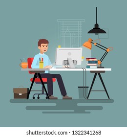 Businessman sitting at desk working on pc.