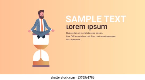 businessman sitting lotus position on sand clock time management deadline concept business man meditating in yoga pose horizontal male character full length copy space