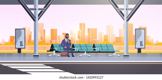 businessman sitting modern bus stop african american business man with suitcase waiting public transport on airport station cityscape background flat horizontal full length