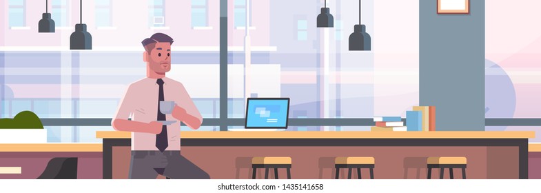 businessman sitting on chair at bar counter with laptop coffee break concept business man drinking cappuccino modern cafe interior flat portrait horizontal