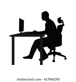 Businessman sitting on office chair at table and working on computer. Side view. Vector silhouette. Man typing in office at desk and staring into monitor