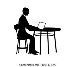 Businessman sitting at table with computer.Vector illustration.Black silhouette.