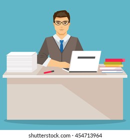 Businessman sitting at the table and working on laptop