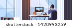businessman sitting at workplace desk rear view business man using computer while talking on landline phone working process concept creative office interior flat horizontal portrait