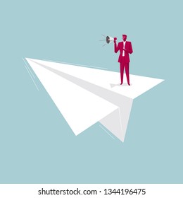 Businessman is speaking on a paper plane. Isolated on blue background.