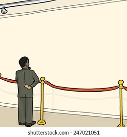 Businessman standing alone looking at wall behind stanchion