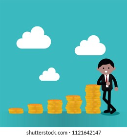 Businessman standing beside stack of coins.