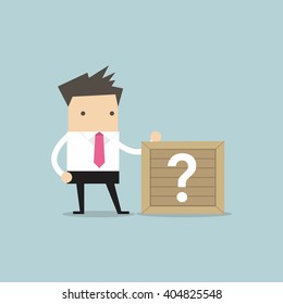 Businessman standing beside unknown box