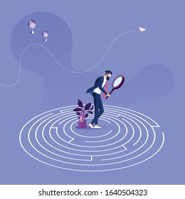 Businessman standing in the center of a maze trying to find way out-Business problem solution concept