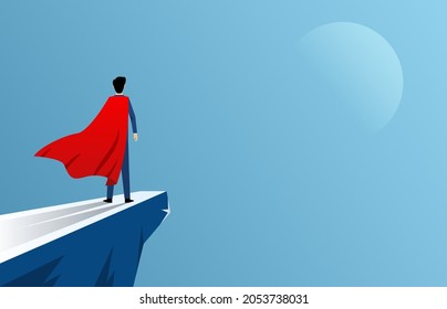 Businessman standing at cliff wearing red cape as superhero, business ambition and courage