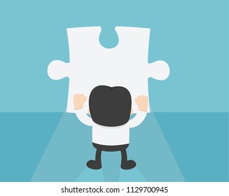 Businessman Standing in front of blank Puzzle Wall to Finding a Lost Piece