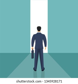 Businessman standing in front of an opened wall door looking to the future.