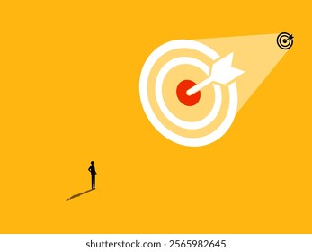 Businessman standing looking at big goal, success oriented concept