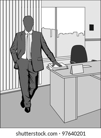 Businessman standing in office at the table with papers