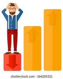 Businessman standing on low graph.