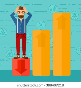 Businessman standing on low graph.