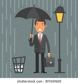 Businessman standing with umbrella in rain