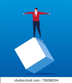 The businessman stands on an unbalanced cube