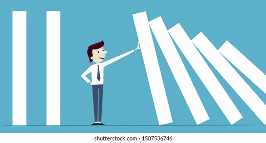 Businessman stops falling of domino
