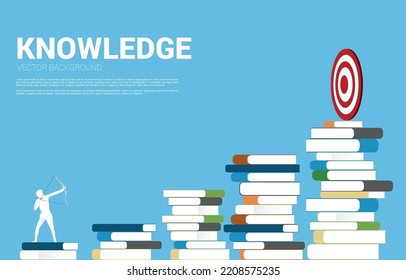 Businessman In Suit Shoot The Arrow On Book Stack. Silhouette Of Businessman Standing On Stack Of Books.