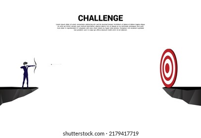 Businessman in suit shoot the arrow to target across the gap. Concept of start business and ready to shoot.