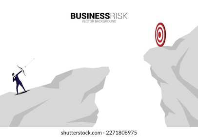 Businessman in suit shoot the arrow to target across the valley. Business Concept of marketing target and customer.