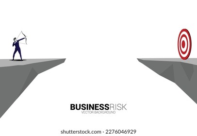 Businessman in suit shoot the arrow to target across the valley. Business Concept of marketing target and customer.